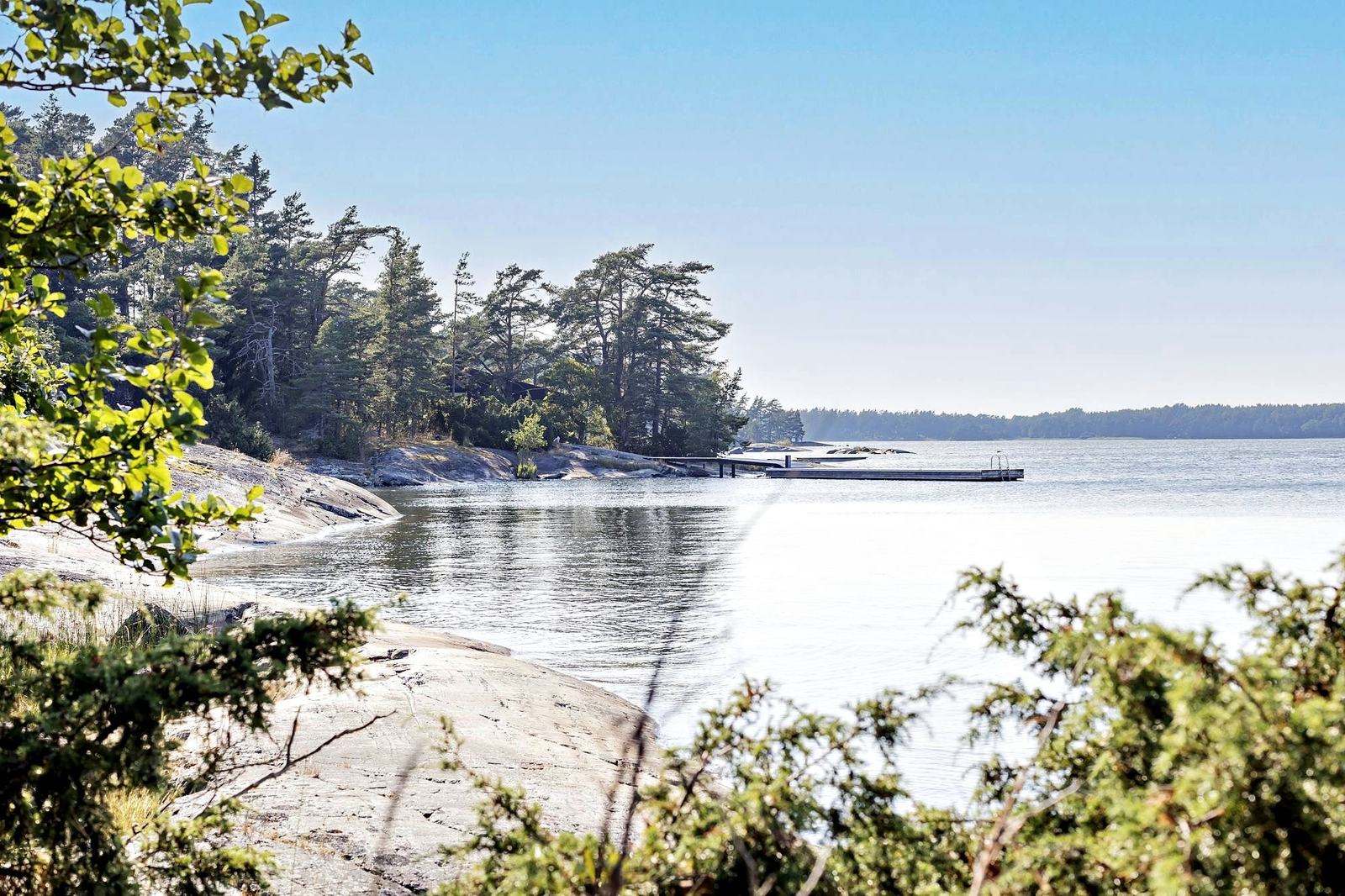 A calm cove between pine-covered islands and smooth granite